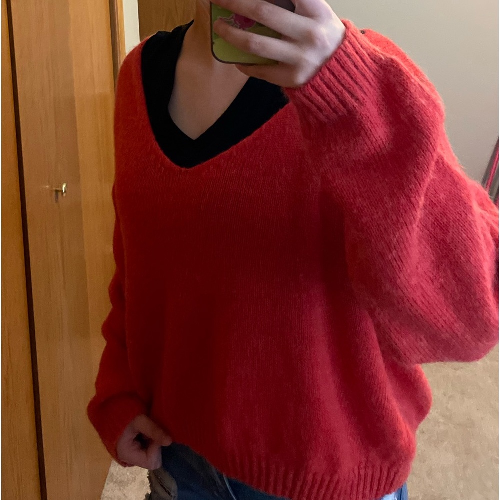 Red knit sweater with ribbing at the bottom